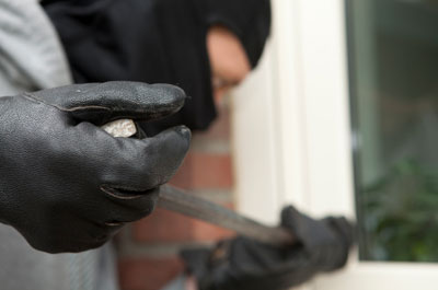 Burglar prying open a door