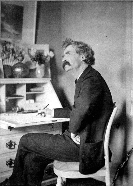 Mark Twain pondering at desk