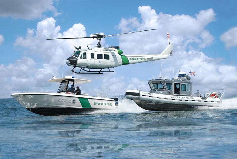Office of CBP Air and Marine helicopter and boats.jpg