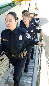 female law enforcement officers boarding a ship