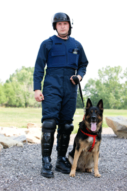 law enforcement degree holder in K-9 Unit holding his dog.