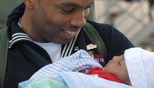 800px-US_Navy_061224-N-9909C-009_A_proud_father_and_Sailor_from_the_destroyer_USS_Halsey_(DDG_97)_holds_his_child_for_the_first_time